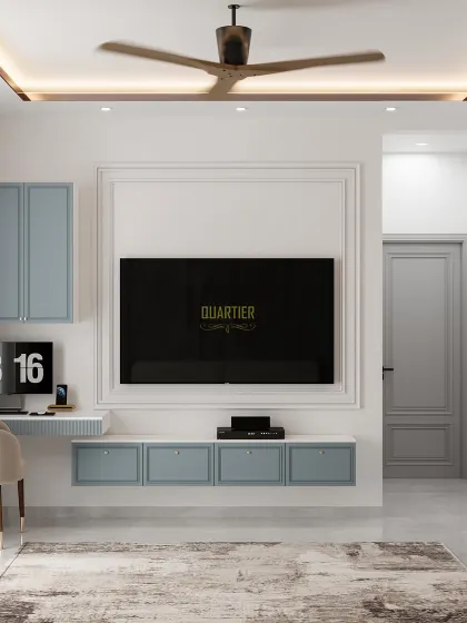 The TV and workstation area of the European-Scandinavian master bedroom. The design uses clean lines, classic trim molding around the TV, and pastel blue cabinetry for a light and airy feel.