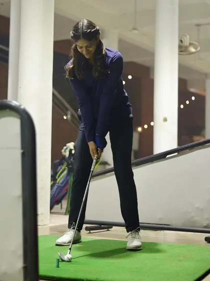 Here you can see the proper setup and posture before initiating the swing. A solid stance is crucial for balance and consistency, which we focus on with all our students.
