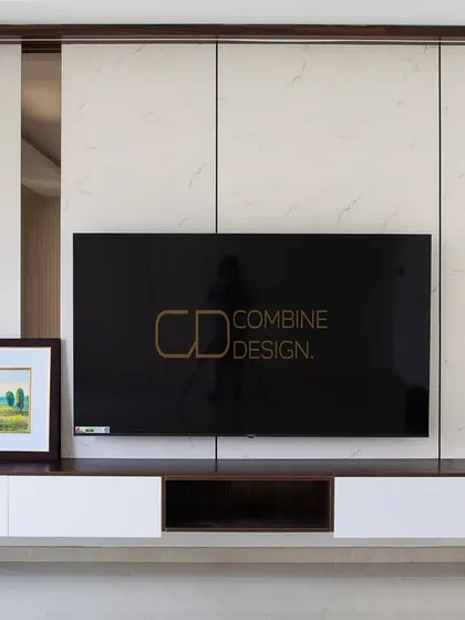 A closer view of the floating TV unit, emphasizing the clean lines and the beautiful contrast between the white marble-finish panels and the dark wood frame. It’s a perfect fusion of function and finesse.