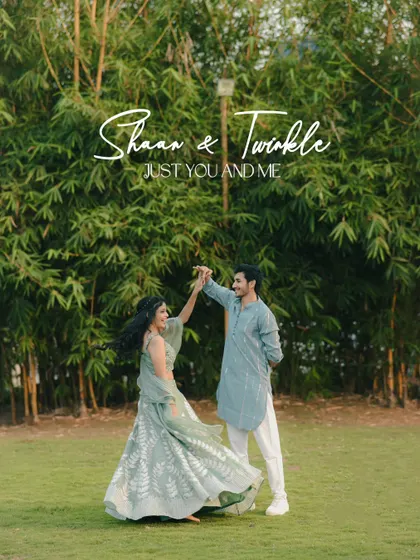 A couple dances joyfully in a lush green garden, dressed in beautiful pastel traditional outfits. This image is full of life, movement, and romance.