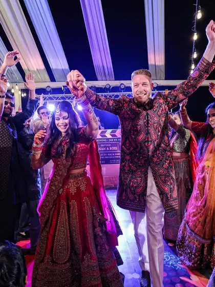 The groom's side brings the energy to the Sangeet. Here, friends and family perform for Sonam and Ross on a custom-designed dance floor, a highlight of the night's celebrations.