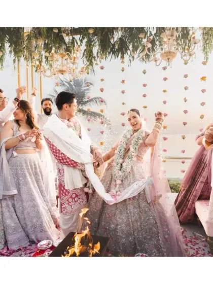 A wide shot of the pheras, capturing the sacred fire, the couple, and their families watching with joy. This image tells the story of two families coming together.
