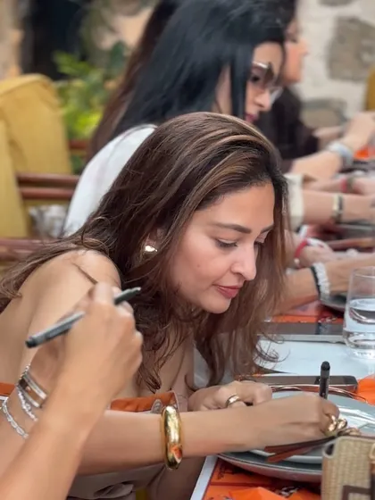A close-up of a guest penning her good wishes, a personal touch that makes the day more meaningful.