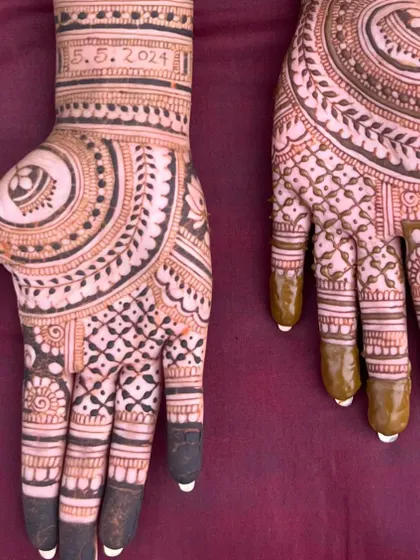 A close-up of the palm details for the engagement mehendi, showing the fine line work and the neatness of the finger designs.
