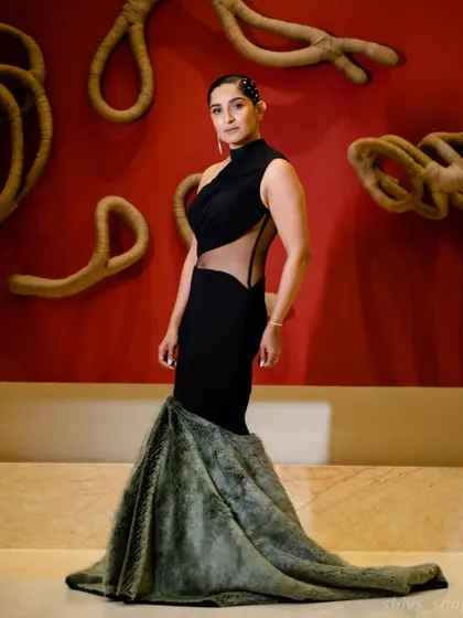 This is one of my more experimental designs. A black mermaid gown with an asymmetric sheer panel at the waist and a dramatic fur-detailed train, created for those who want a bold, high-fashion statement.