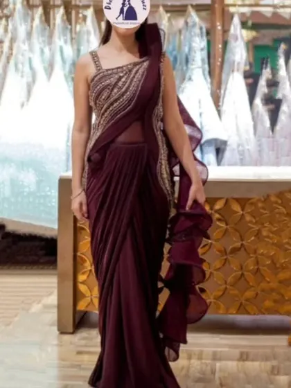 A full length view of the draped saree gown, showing the ruffled pallu detail.