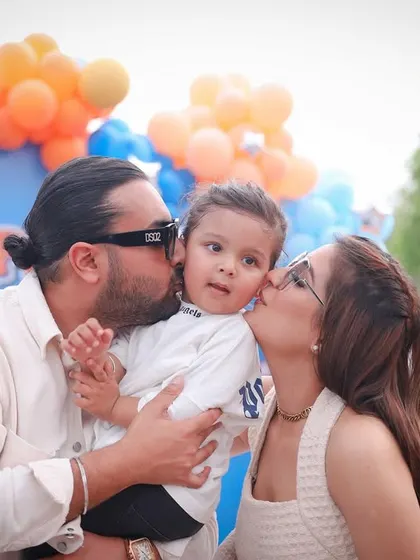 Kisses for the birthday boy! A beautiful family moment from a 2nd birthday party, full of love and affection.