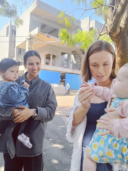 Mothers and their toddlers enjoy a sunny day out, exploring the neighborhood as part of our parent-toddler program.