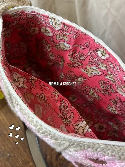 A peek inside reveals a beautiful floral lining and a handy inner pocket, ensuring your belongings are safe and organized.