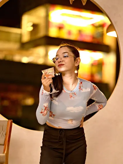 A guest enjoying the fresh cocktails and rooftop views at JU:CY Wednesdays. It's all about creating a space where people can relax and have a good time.
