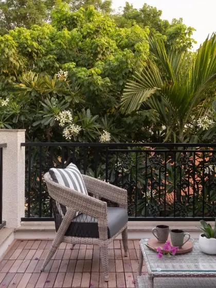 An all-weather wicker chair on a client's balcony. While I specialize in teak, I also source complementary pieces to complete indoor-outdoor spaces.