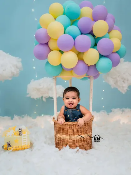 A happy half birthday. This hot air balloon theme is perfect for celebrating the six-month milestone, capturing that adorable sitting-up stage with a whimsical setup.