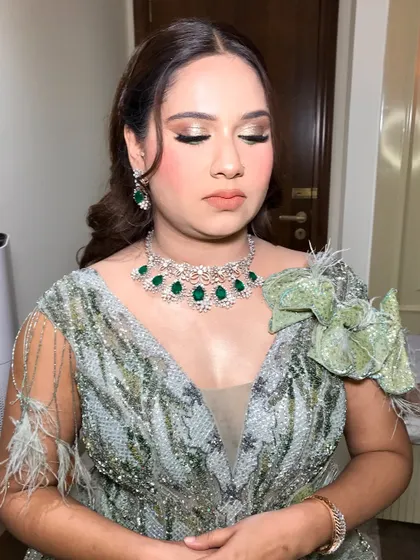 A close-up of the shimmering eye makeup, with beautifully blended shades of gold and green.