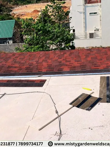 Work in progress on a shingles pergola on Bannerghatta Road. This image shows the layering process of the shingles over the roof base, a crucial step for ensuring a waterproof and long-lasting finish.