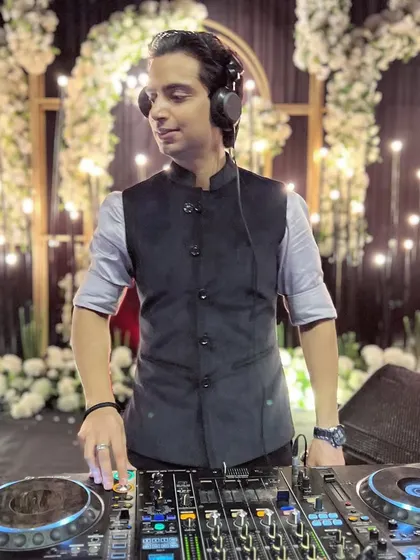 Another angle of me at the console, feeling the music. The warm, glowing background adds to the sophisticated atmosphere of the event.