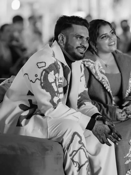 A quiet moment amidst the joyful chaos. The decor serves as a beautiful backdrop for the couple as they soak in the celebration designed just for them.