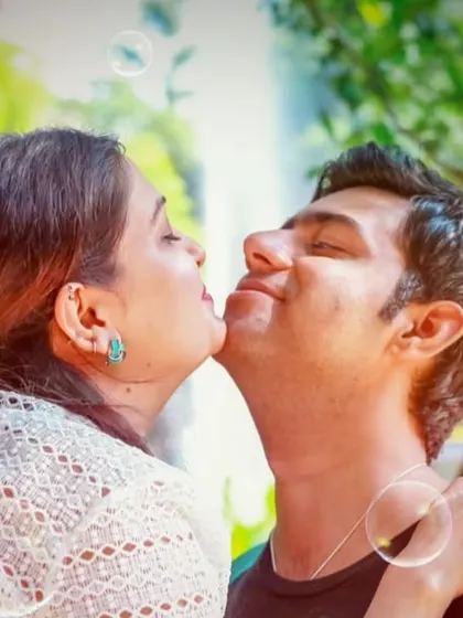 A sweet and candid moment during a pre-wedding shoot, with bubbles adding a touch of whimsy and fun to the photograph.