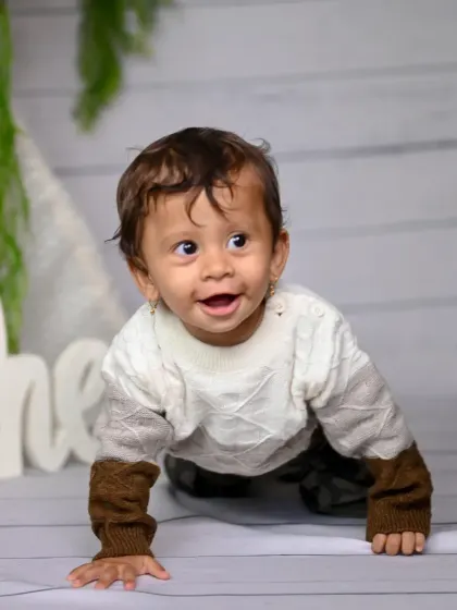 A duplicate of image 143, capturing a happy crawling baby.