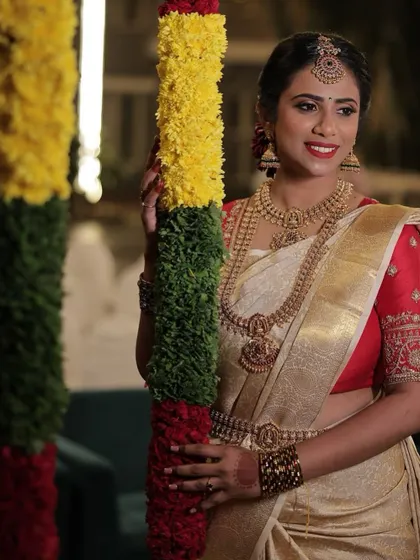 A happy, smiling portrait of Anusha. The airbrush makeup ensures she looks flawless and radiant throughout her big day.