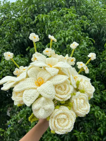 An elegant all-white custom bouquet featuring lilies, roses, and forget-me-nots.