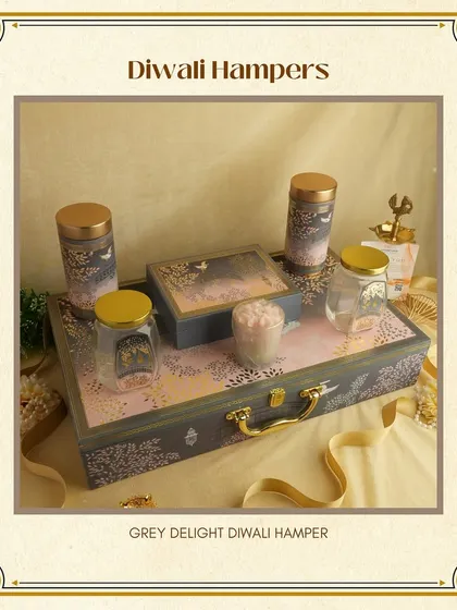 The "Grey Delight" Diwali Hamper is a sophisticated choice. The elegant grey suitcase-style box is filled with matching jars and premium items for a coordinated look.