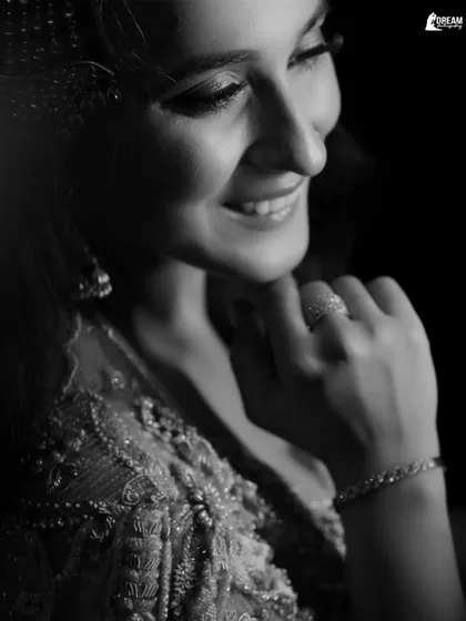 A classic black and white close-up of Manya, her joyful smile being the centerpiece of this timeless portrait.