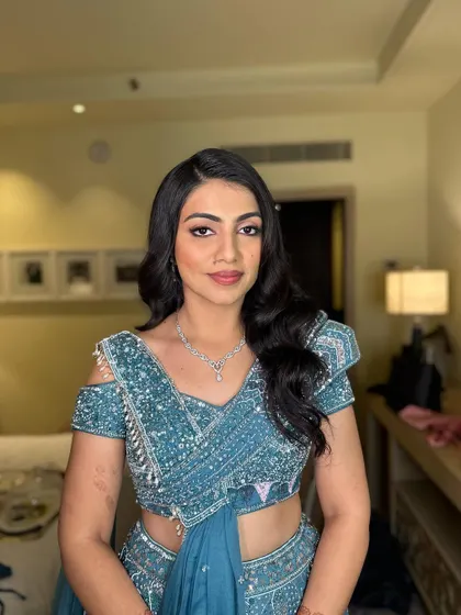The final look is a perfect blend of classic hairstyle and contemporary fashion, ideal for a wedding reception or cocktail party.