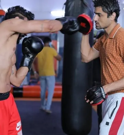 A focused shot of Rahul Makin delivering a powerful straight right during our one-on-one boxing session. We focus on clean technique to maximize impact and efficiency in every punch.