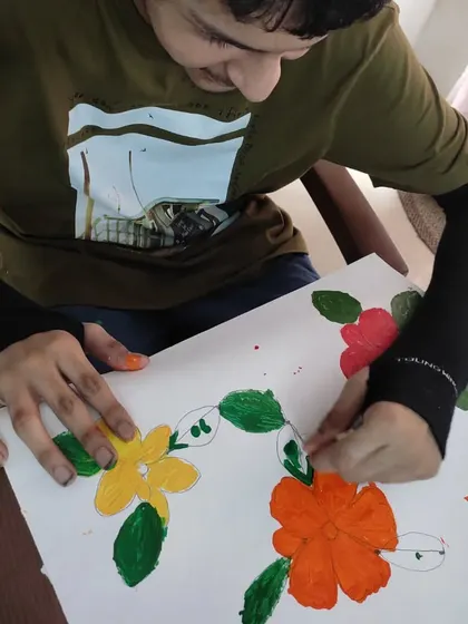 This young artist is carefully adding details to his floral painting. Art camp is a space for exploration, imagination, and observation, and it's a joy to see them so engaged.