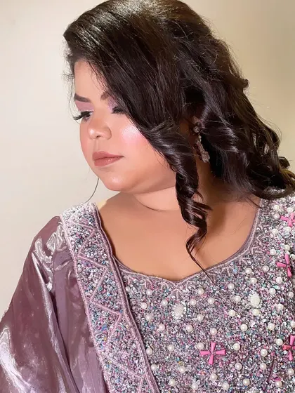 A close-up of the makeup, featuring soft pink tones on the eyes and cheeks.