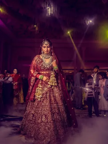 A wide shot of the bride's entrance, capturing the attention of all the guests as she walks through a cloud of fog.