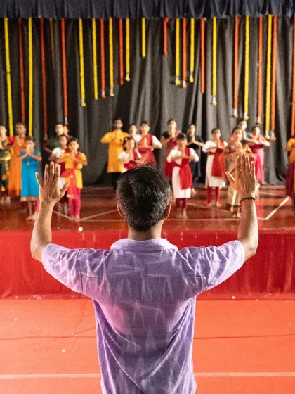 From my perspective as a guru, guiding my students on stage during a rehearsal. It is my role to shape the collective energy and ensure every detail is perfect.
