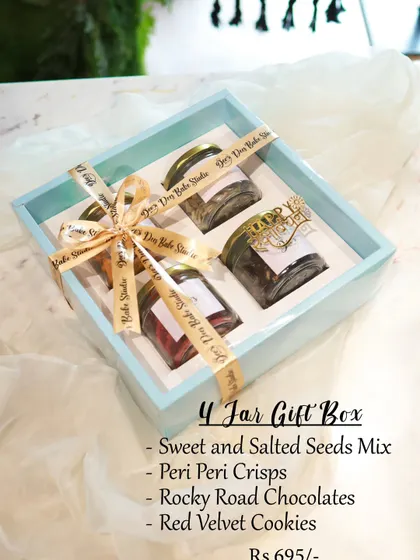 A simple and elegant 4 Jar Gift Box, perfect for any occasion. This one for Rakhi contains a sweet and salted seeds mix, peri peri crisps, rocky road chocolates, and red velvet cookies.