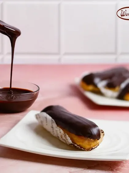 A classic French Chocolate Eclair, filled with delicate cream and topped with a rich, glossy chocolate glaze. This is one of the timeless pastries that our regulars have loved since the very beginning.