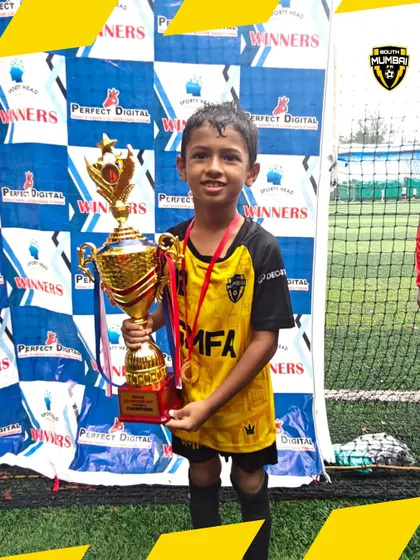 A young champion from our U8 squad proudly holding the tournament trophy. This is the result of heart, hustle, and relentless spirit.