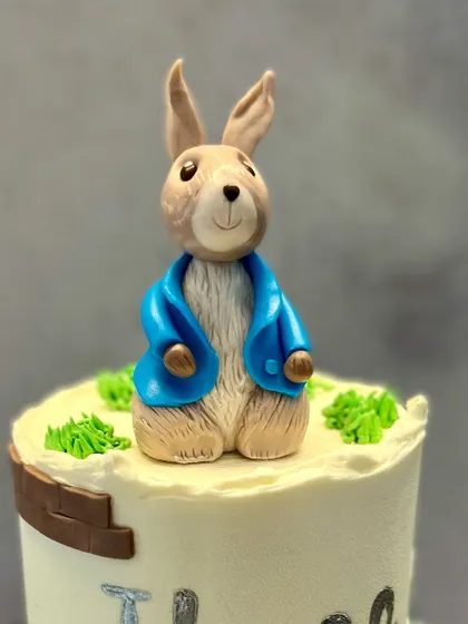A close-up of the handmade Peter Rabbit fondant topper. I put a lot of care into sculpting these figures to capture the character's personality.