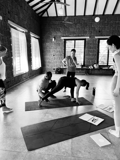 Our 200-hour Hatha Yoga Teacher Training goes beyond asana to help you understand yourself. This photo captures a moment of learning, where teachers practice adjusting each other to build confidence and skill.