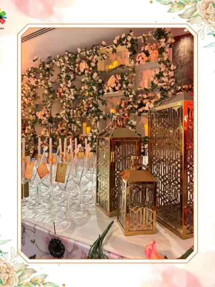 A beautifully arranged bar with custom props, including floral arrangements and ornate lanterns, creating a romantic and sophisticated atmosphere.