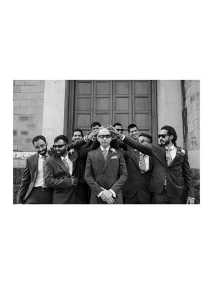 A cool, fun black and white shot of the groom and his groomsmen, perfectly capturing their bond and stylish flair.