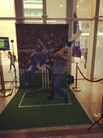 An action shot of a player fully engaged in our VR cricket game. The combination of the headset's visuals and the physical bat controller provides a realistic batting experience that is both challenging and incredibly fun.