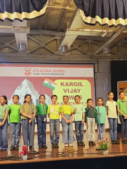 The school choir presents a patriotic song during the Kargil Vijay Diwas assembly, filling the hall with a sense of national pride.