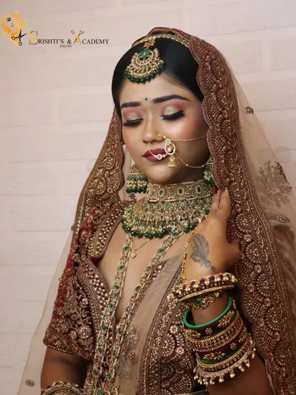 A close-up of the final look created for our demonstration. The soft pink and gold eyeshadow beautifully complements the deep red of the bridal outfit.