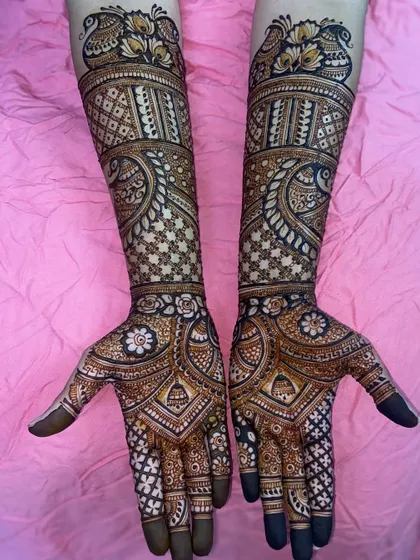 A stunning design with peacocks at the top and a beautiful blend of star-like floral patterns and traditional paisleys.