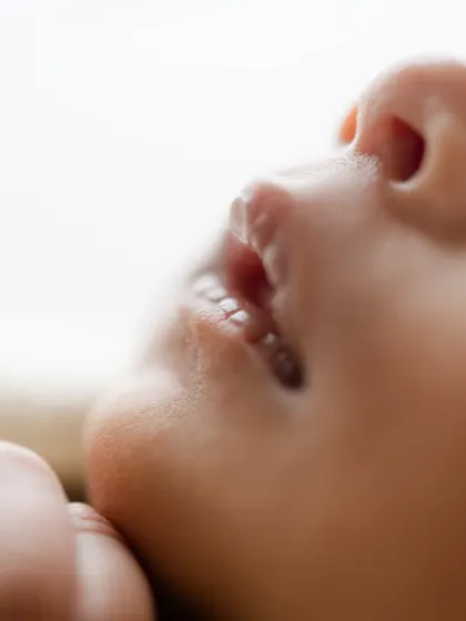 A macro shot of a newborn's lips. We capture these details to help you remember every perfect feature.