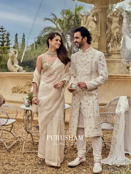 Dressed in 'Amore', this couple redefines tradition with sophistication. The groom's sherwani features intricate gold embroidery, perfectly complementing his bride's attire.