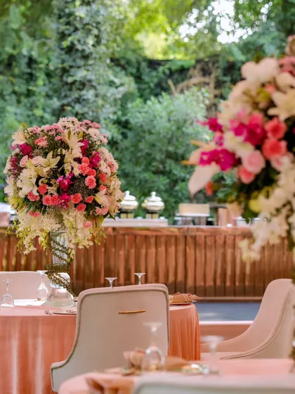 Tall, overflowing floral centerpieces create a sense of grandeur at this pastel-themed luncheon.