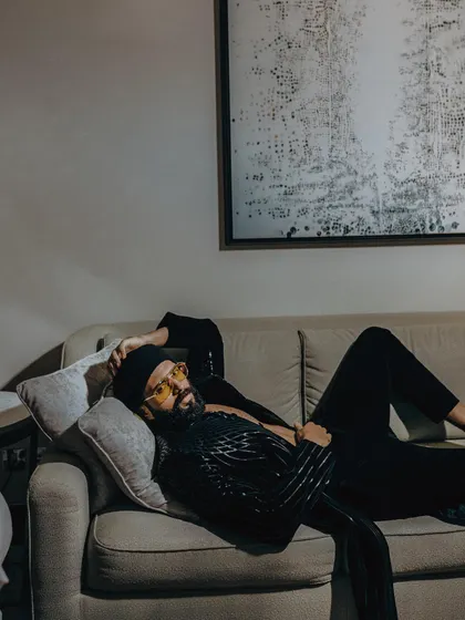 Even when lounging, the style is undeniable. Vijay Deverakonda proves that a statement piece like this Amit Aggarwal jacket is versatile enough for any pose.