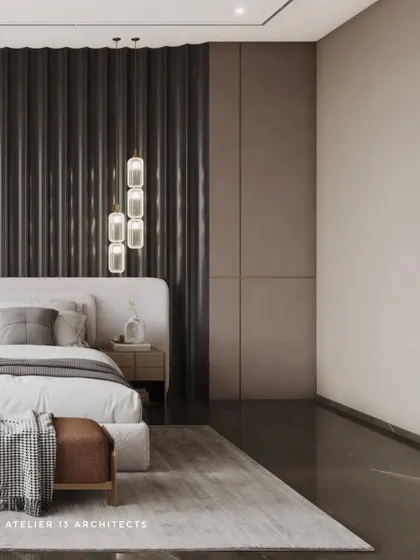 A wider view of the bedroom with the fluted back paneling, showing how the dark wall anchors the space. The design is minimalist yet rich in texture, with pendant lights adding a soft glow.