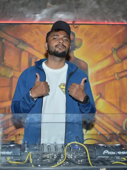 Thumbs up from the DJ booth. A signal to the crowd that the vibe is right and we're all in this together. This is authentic energy.