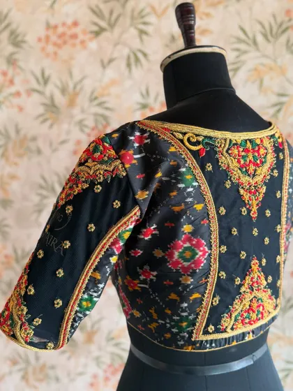 A closer look at the custom Ikat-style blouse. You can see my "AMAIRA" signature embroidered on the sleeve, a personal touch on all my creations.